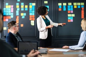 Woman with post it notes leading meeting